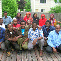 Group of Somali Bantu men and women on backyard deck